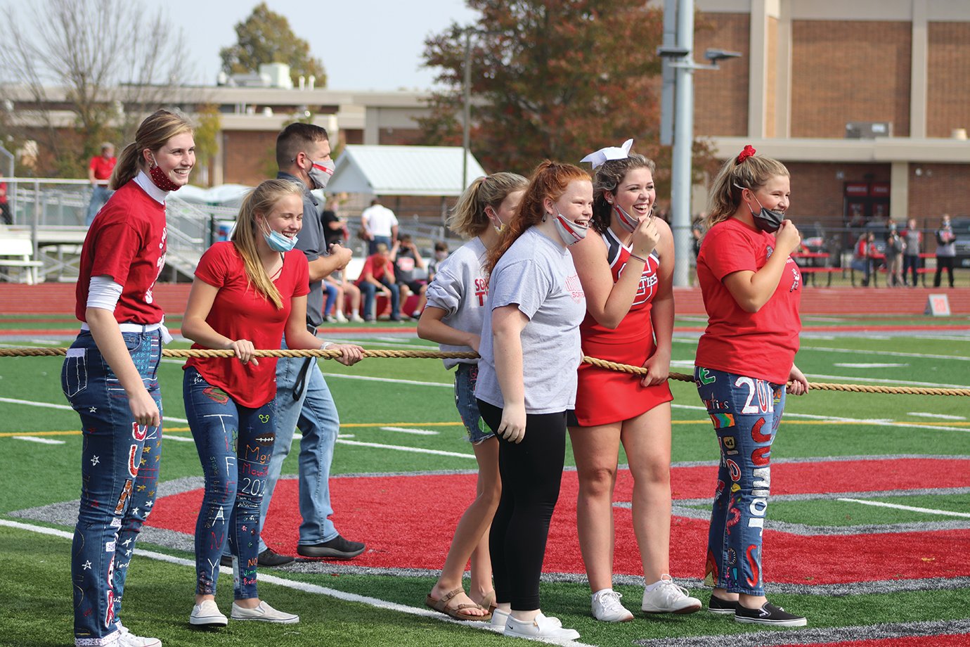 Freshmen students and teachers await one more participant for a contest in tug of war.